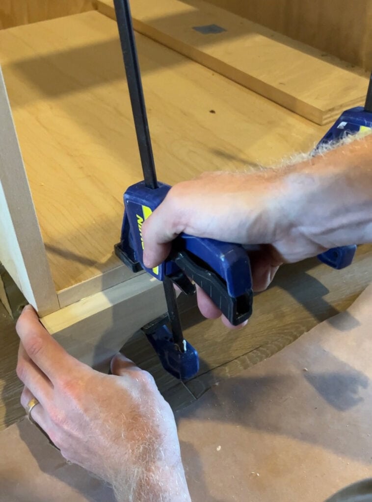 clamping down furniture feet on a cabinet box