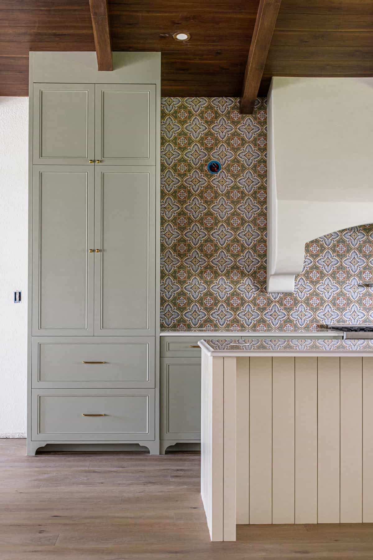 spanish style kitchen with sage green cabinets