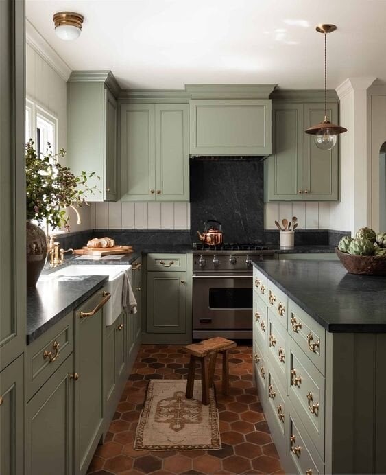 Sage green kitchen cabinets in a green color palette apartment