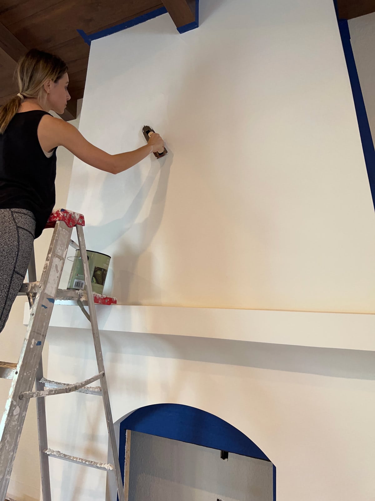 applying first coat of venetian plaster on a fireplace