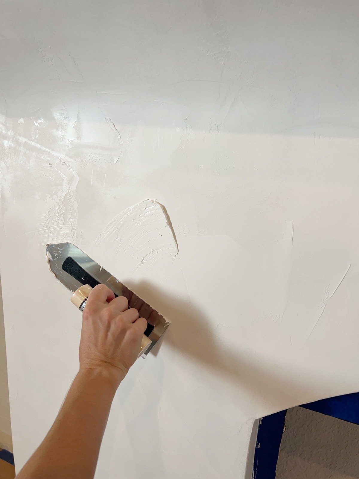 closeup applying venetian plaster on a fireplace