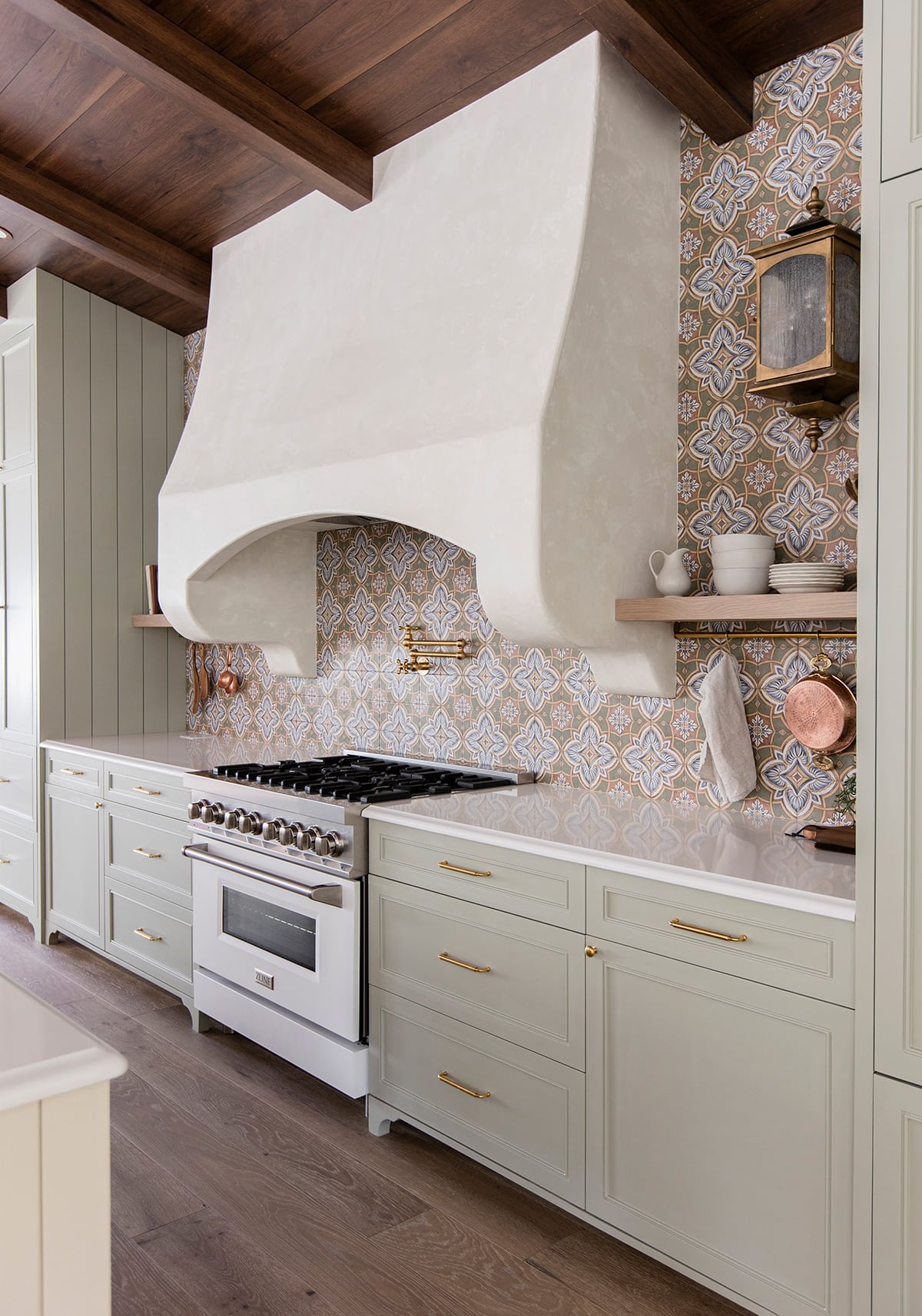 sage green kitchen cabinets and patterned tile