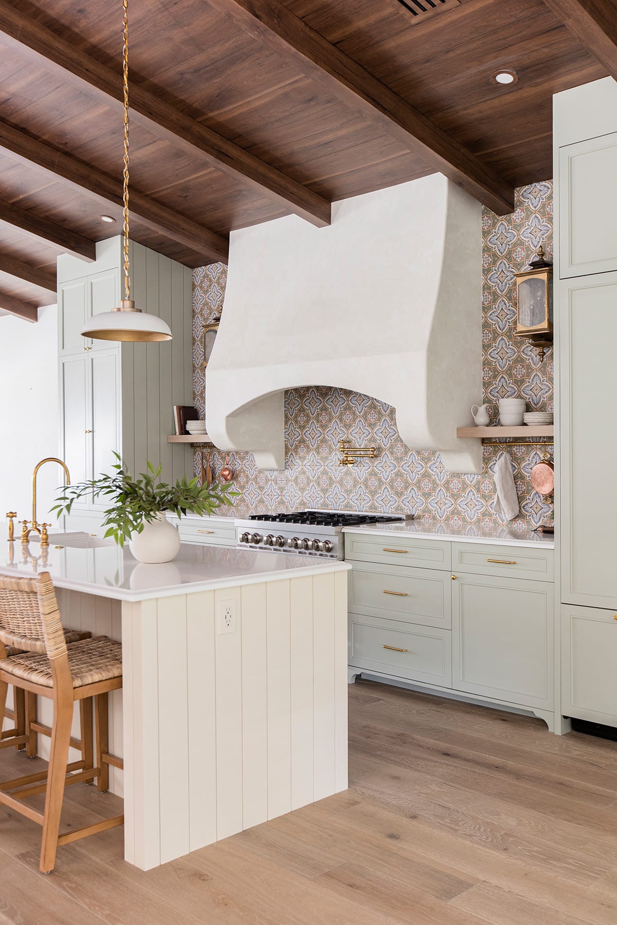 sage green cabinets and ivory kitchen island