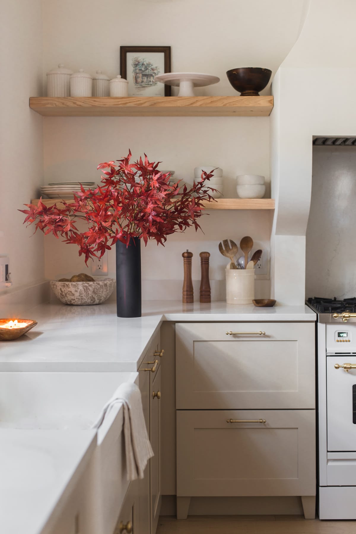 neutral kitchen with red faux japanese maple leaves in vase