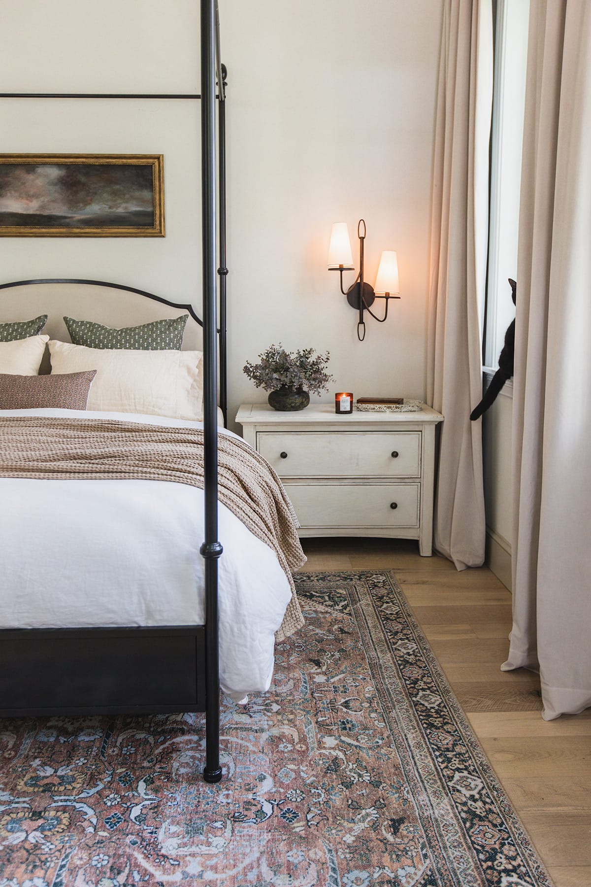 neutral bedroom with canopy bed and curtains