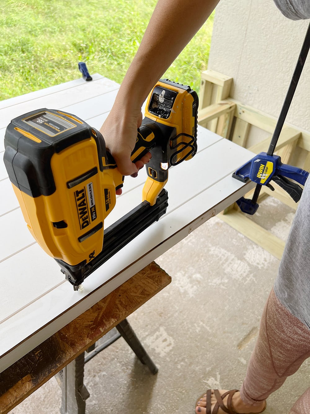 nailing a shiplap panel onto a door