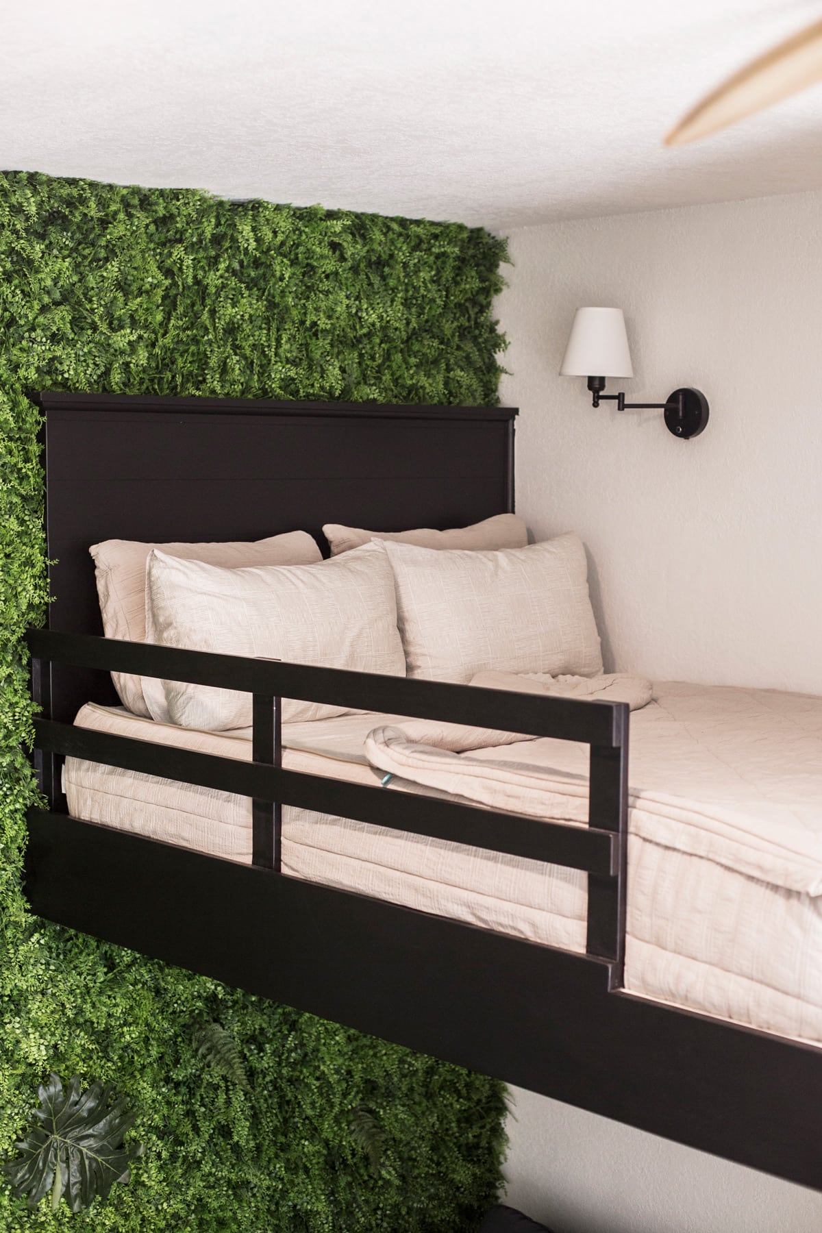 diy loft bed with vine wall and sconce