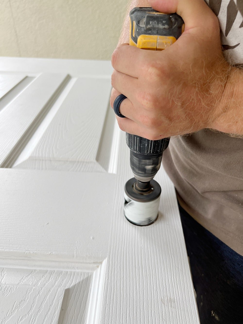 using a hole saw to cut a door bore hole