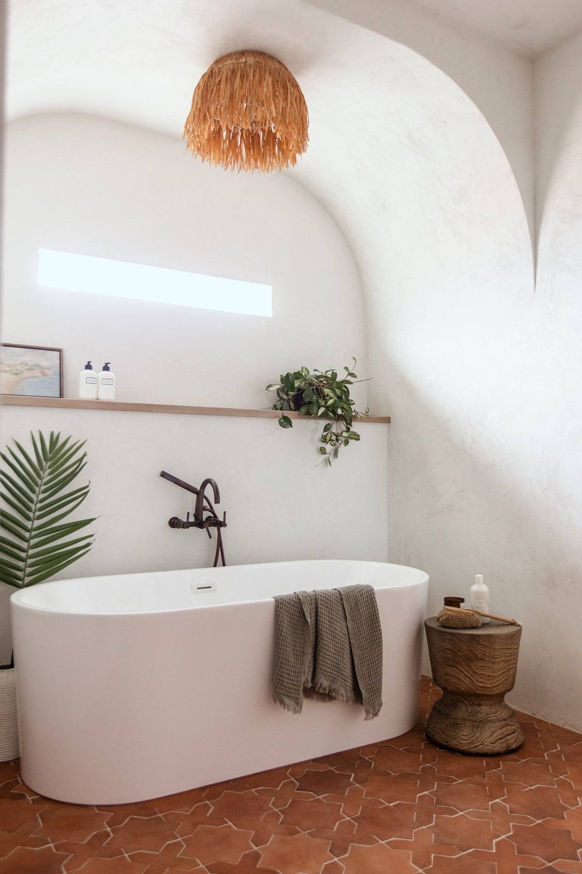 modern mediterranean bathroom with microcement walls and a tub alcove