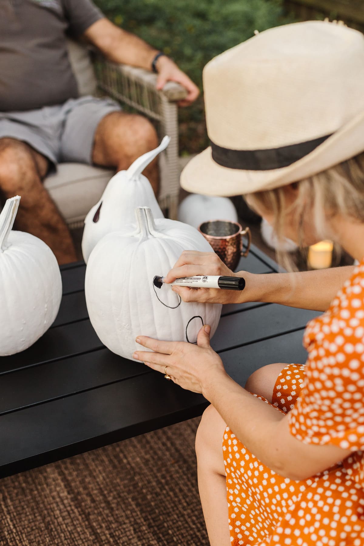 drawing ghost faces on white pumpkins