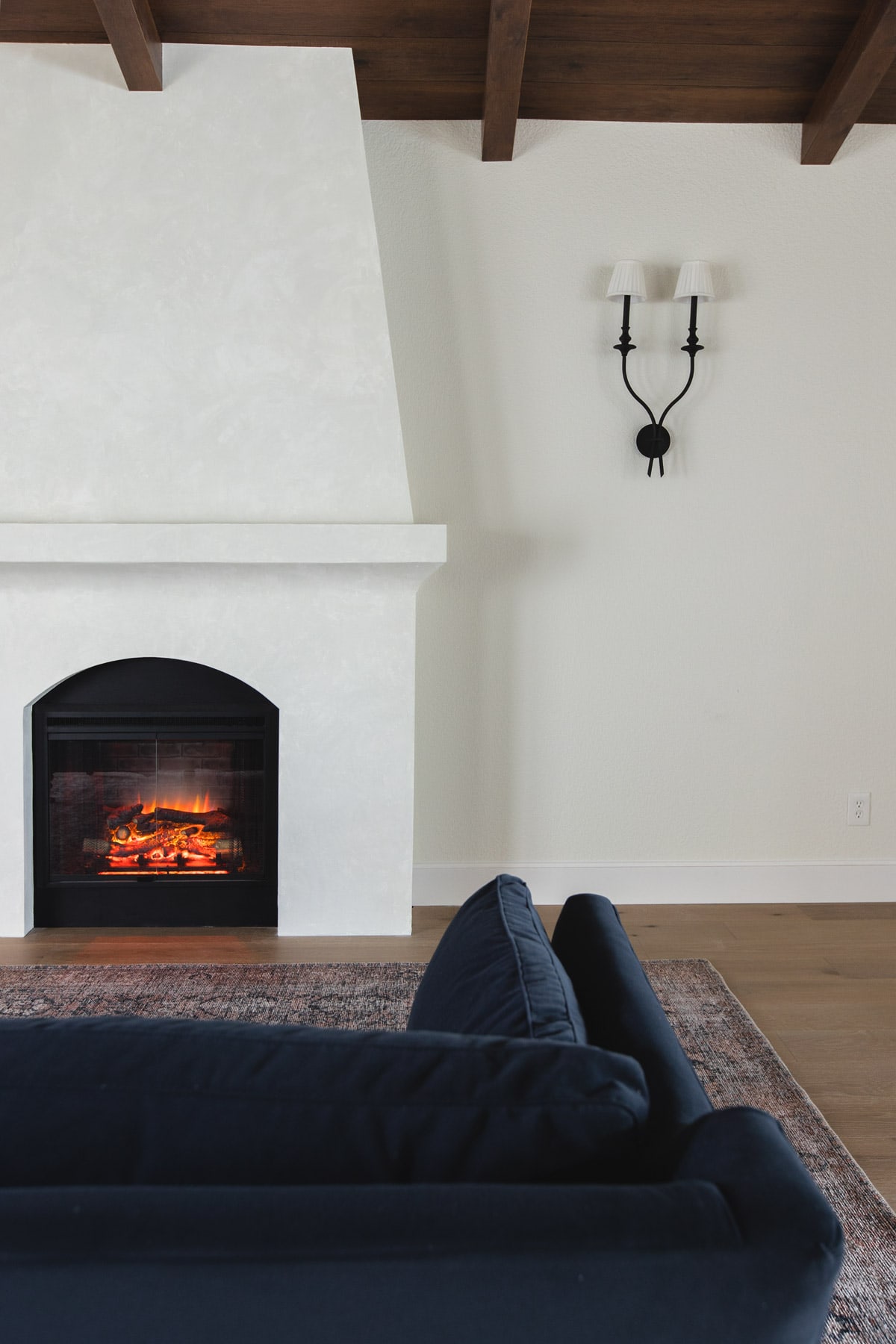 spanish style living room with wood beam ceilings and fireplace