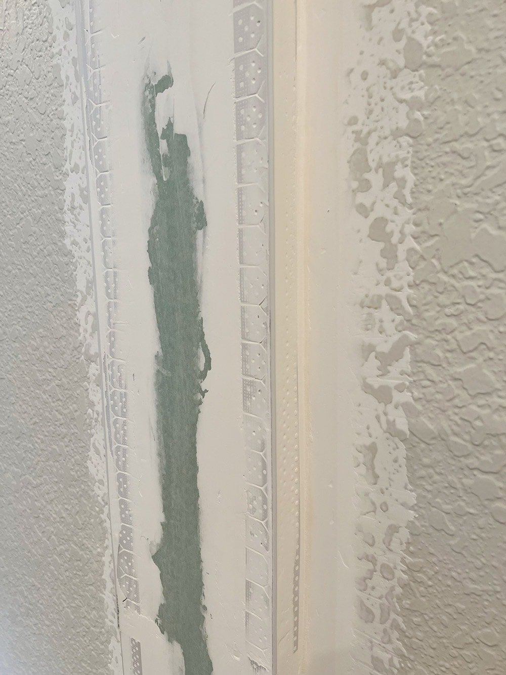 installing joint tape and corner bead for diy drywall arches