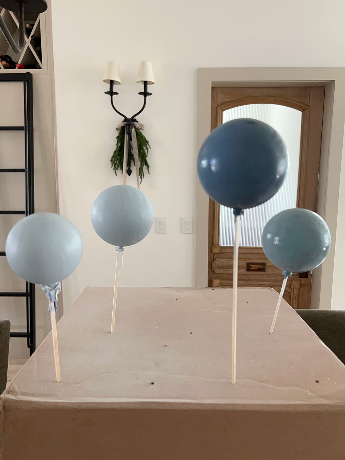 diy painted blue ornaments drying