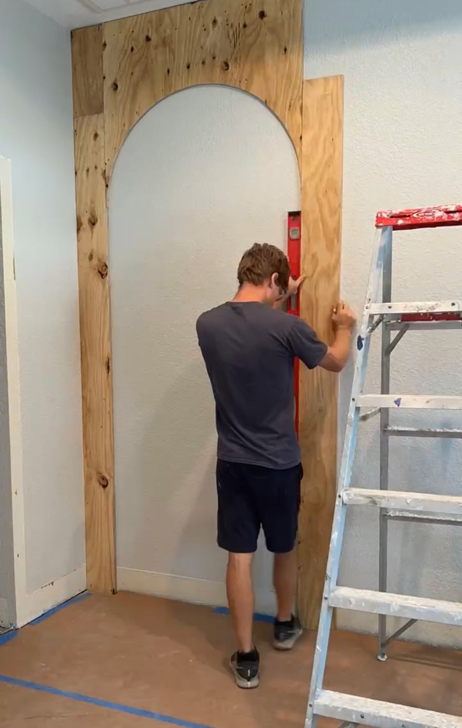 installing plywood arches on wall