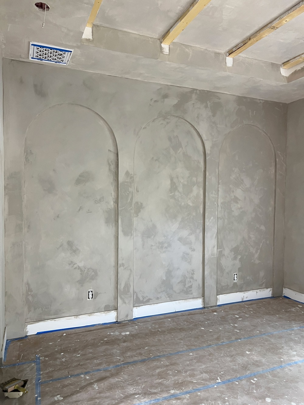 soft taupe limewash wall arches