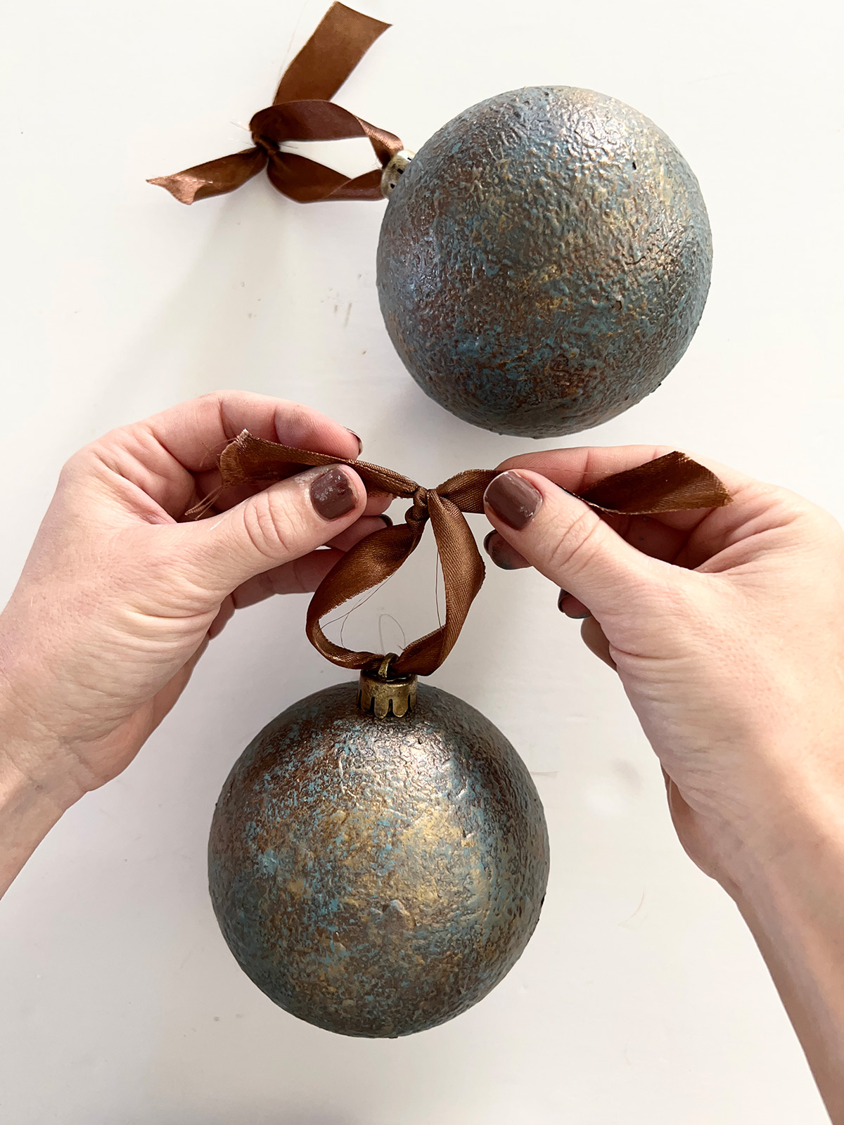 diy aged patina iron christmas ornaments with ribbon