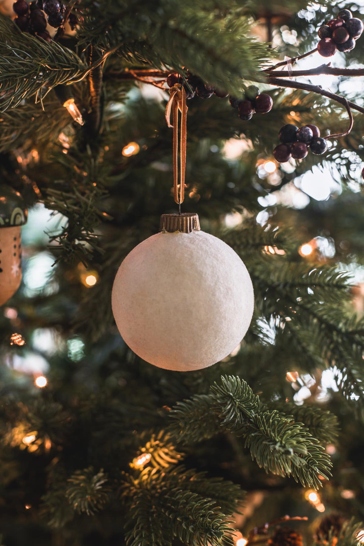 white velvet christmas ornament on tree