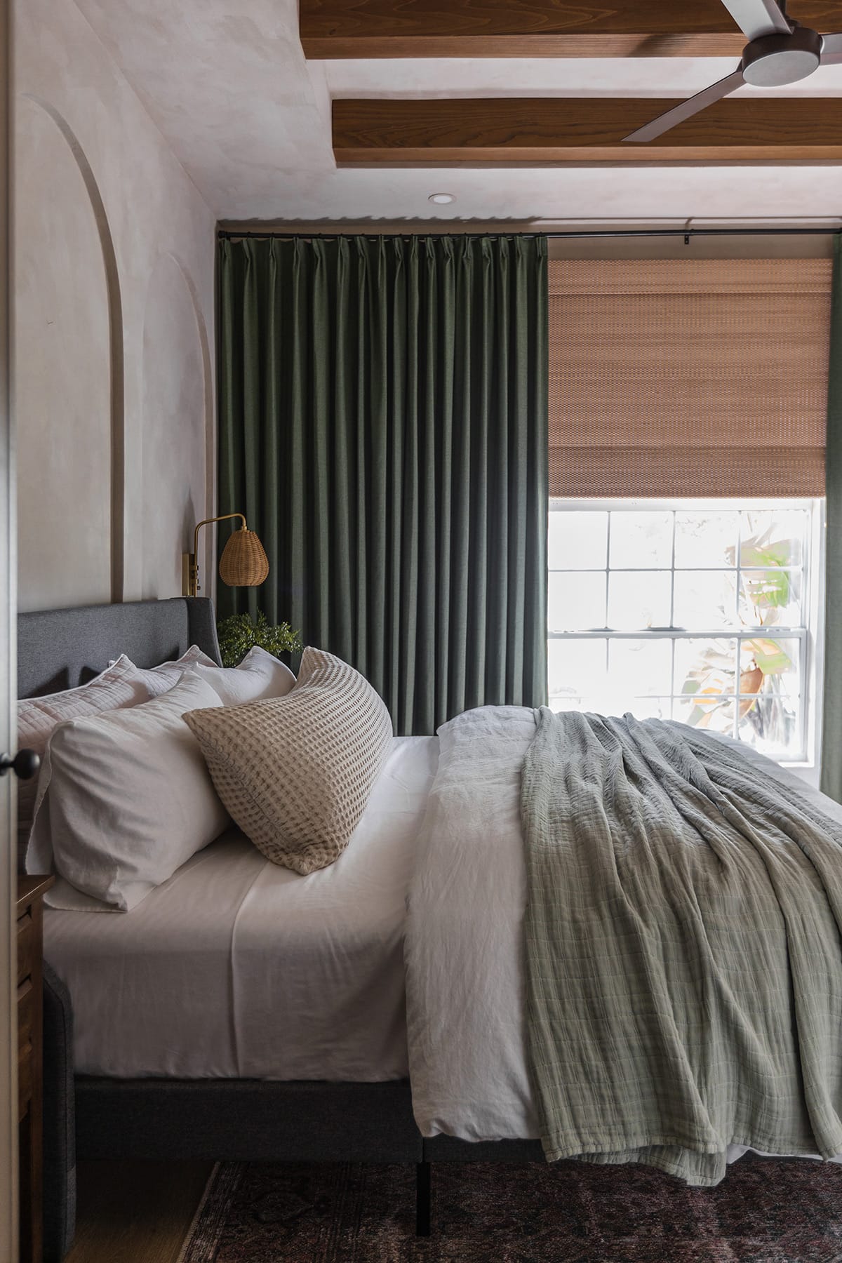 cozy guest bedroom with dark green curtains