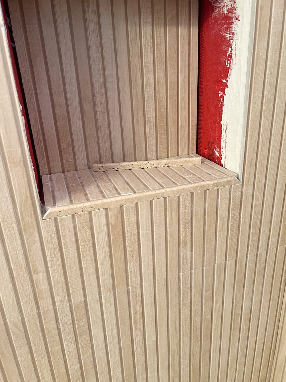 wood ribbon tile in shower niche
