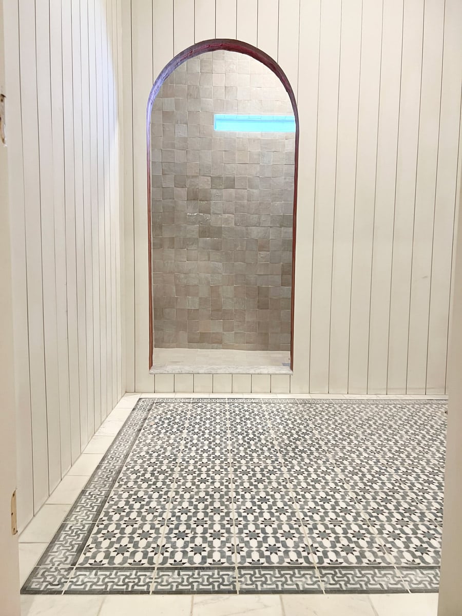 arched shower opening with shiplap walls, moroccan floor tile and zellige shower tile