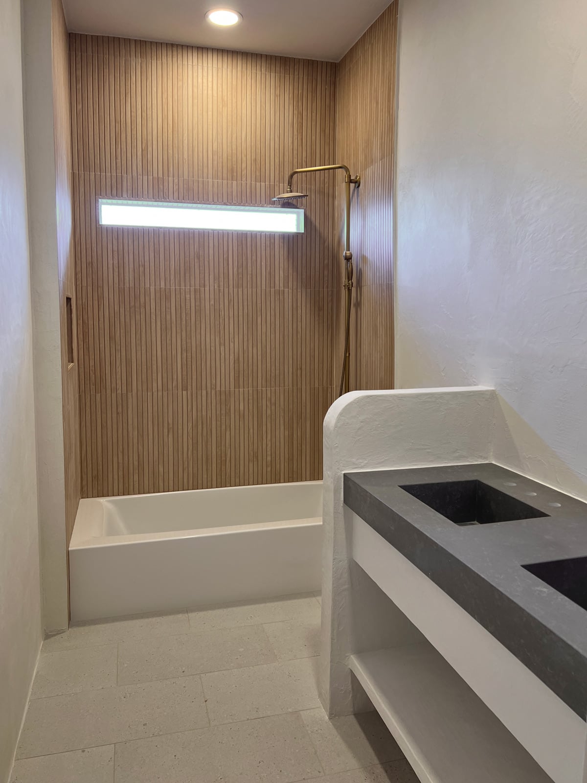 bathroom with microcement walls and wood tile shower