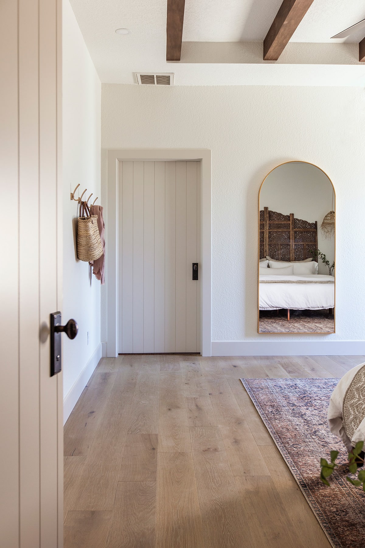 neutral bedroom with alabaster walls and natural tan doors and trim