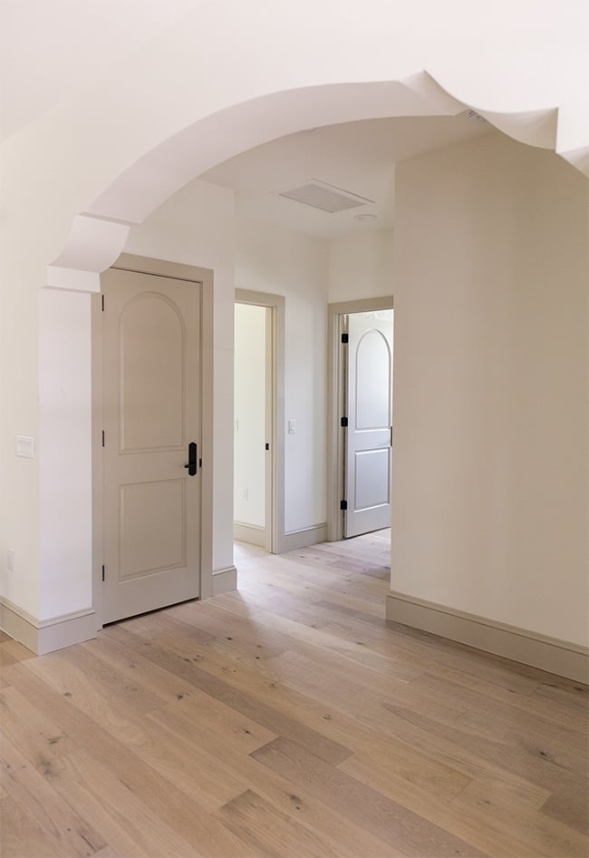 sherwin williams accessible beige on doors and trim in a hallway with alabaster walls