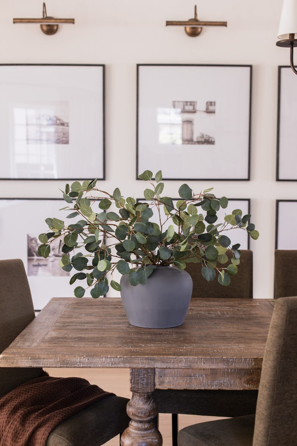 artificial eucalyptus branches in vase on dining table