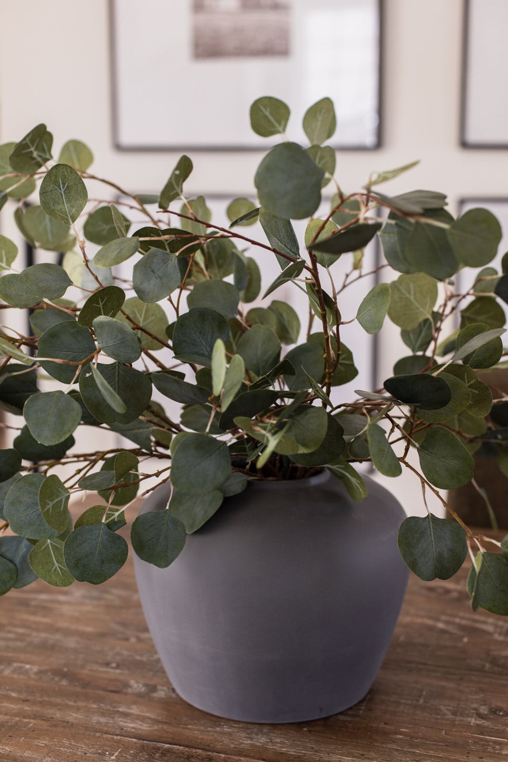 artificial eucalyptus branches in vase on dining table