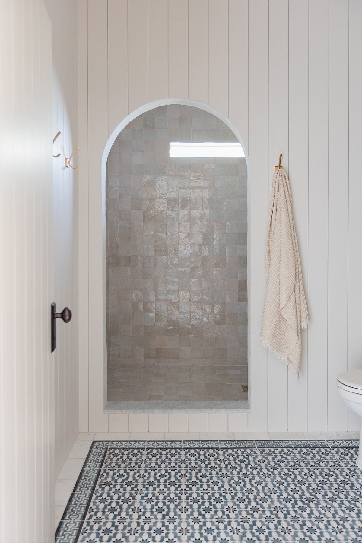 bathroom with arched shower opening, sherwin williams egret white walls