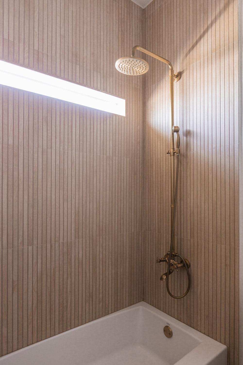 shower with wood look ribbon tile