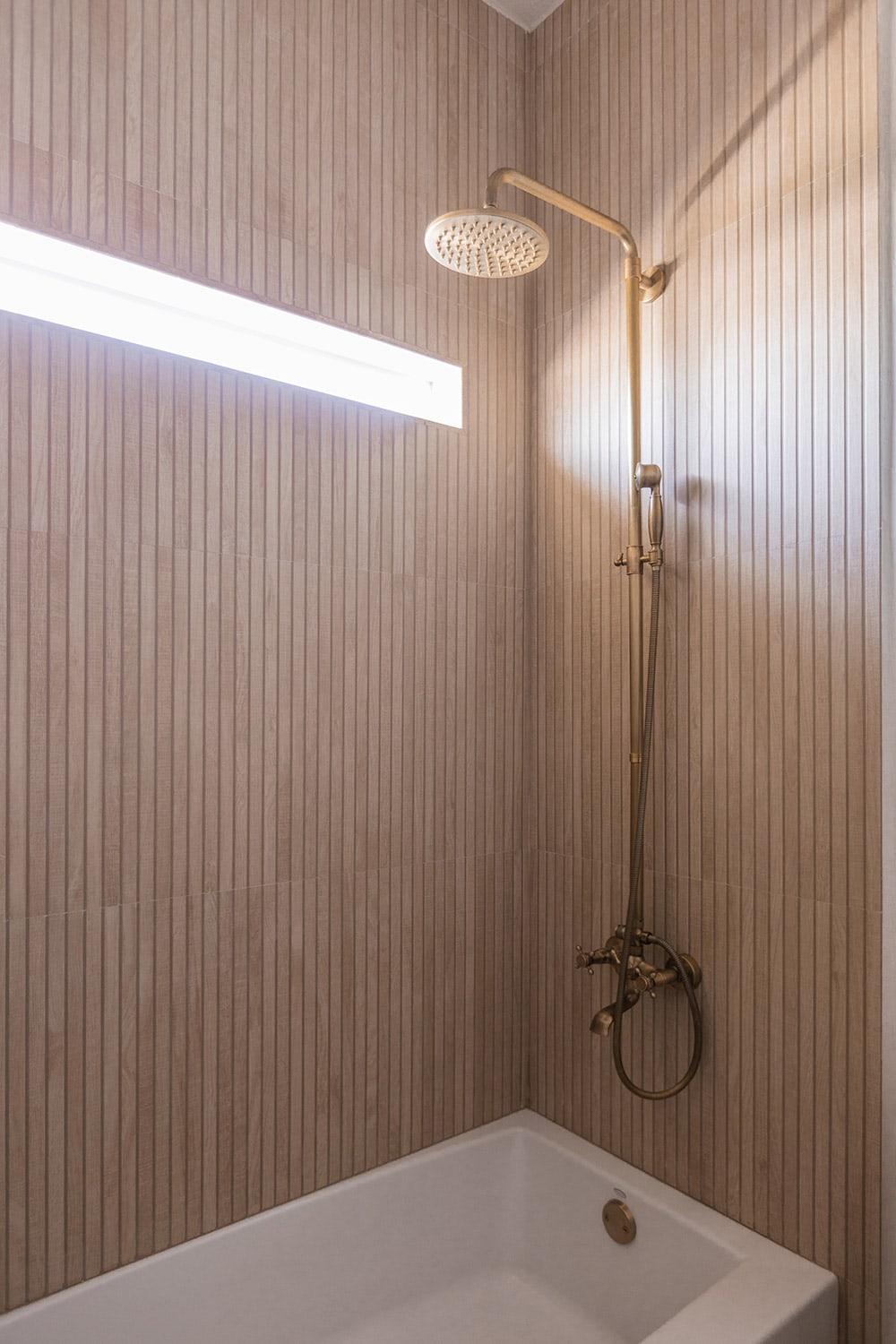 shower with wood look ribbon tile