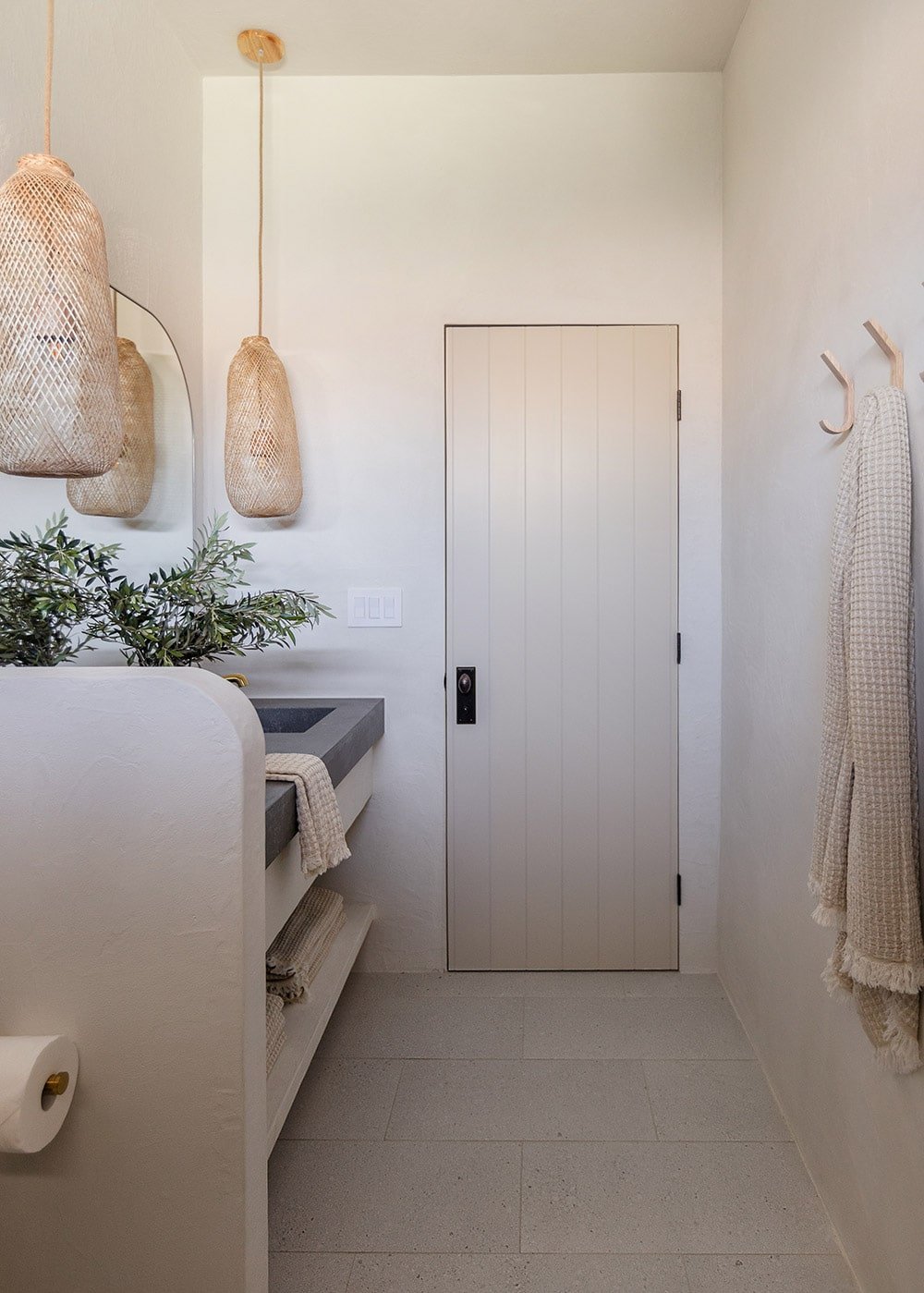 bathroom with microcement walls, custom vanity and quartz counters with integrated sinks