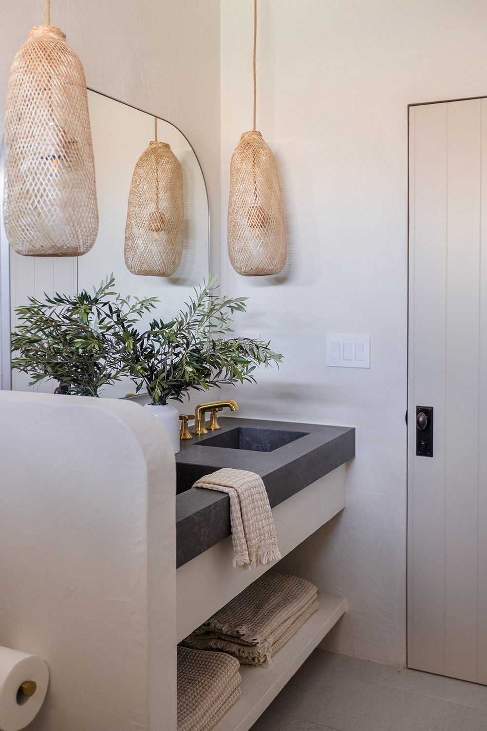 bathroom with microcement walls, custom vanity and quartz counters with integrated sinks