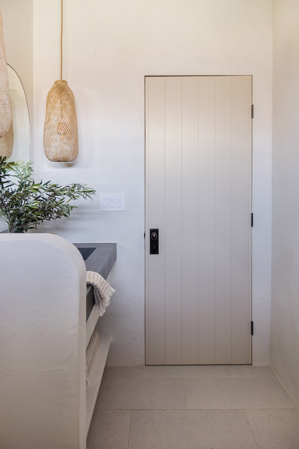 bathroom with microcement and natural tan plank door