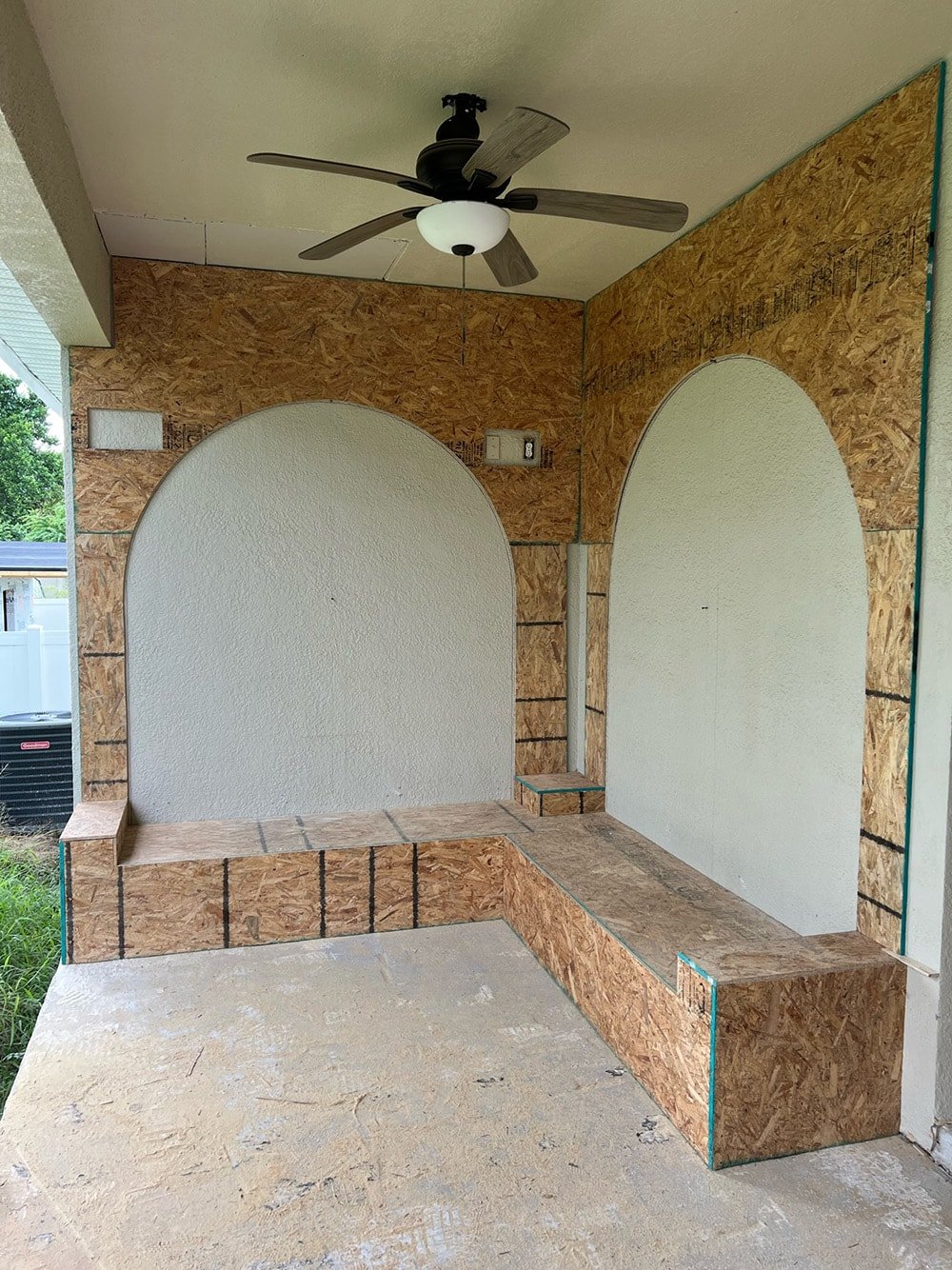 diy custom built in seating with arches on a porch