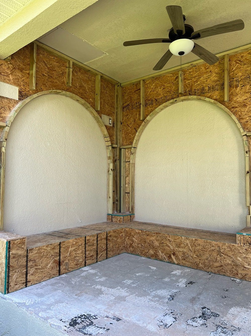 diy custom built in seating with arches on a porch