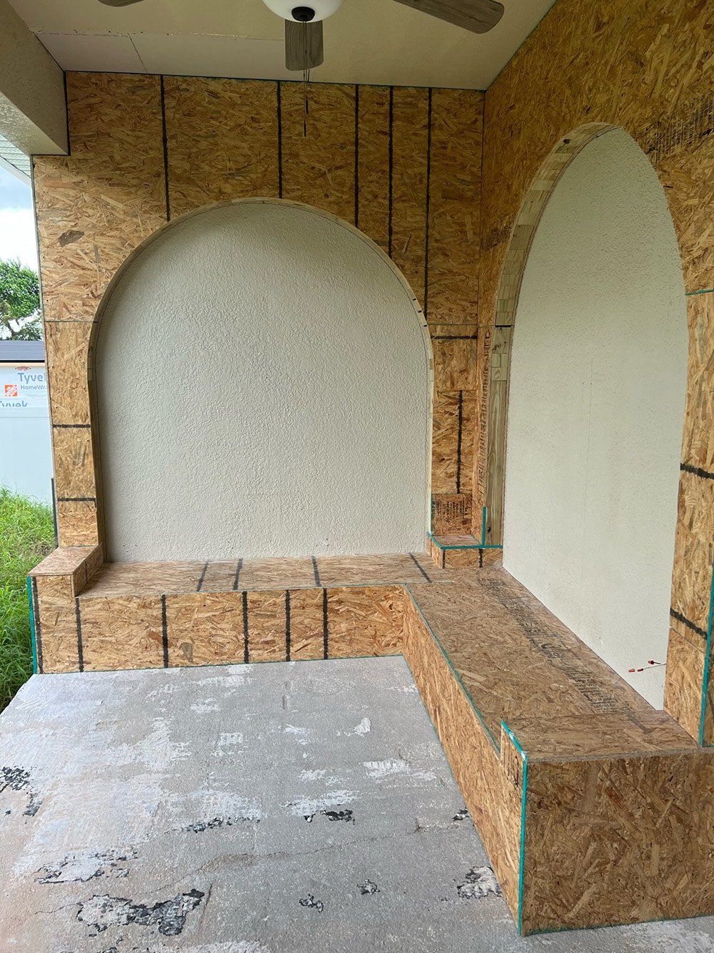 diy custom built in seating with arches on a porch