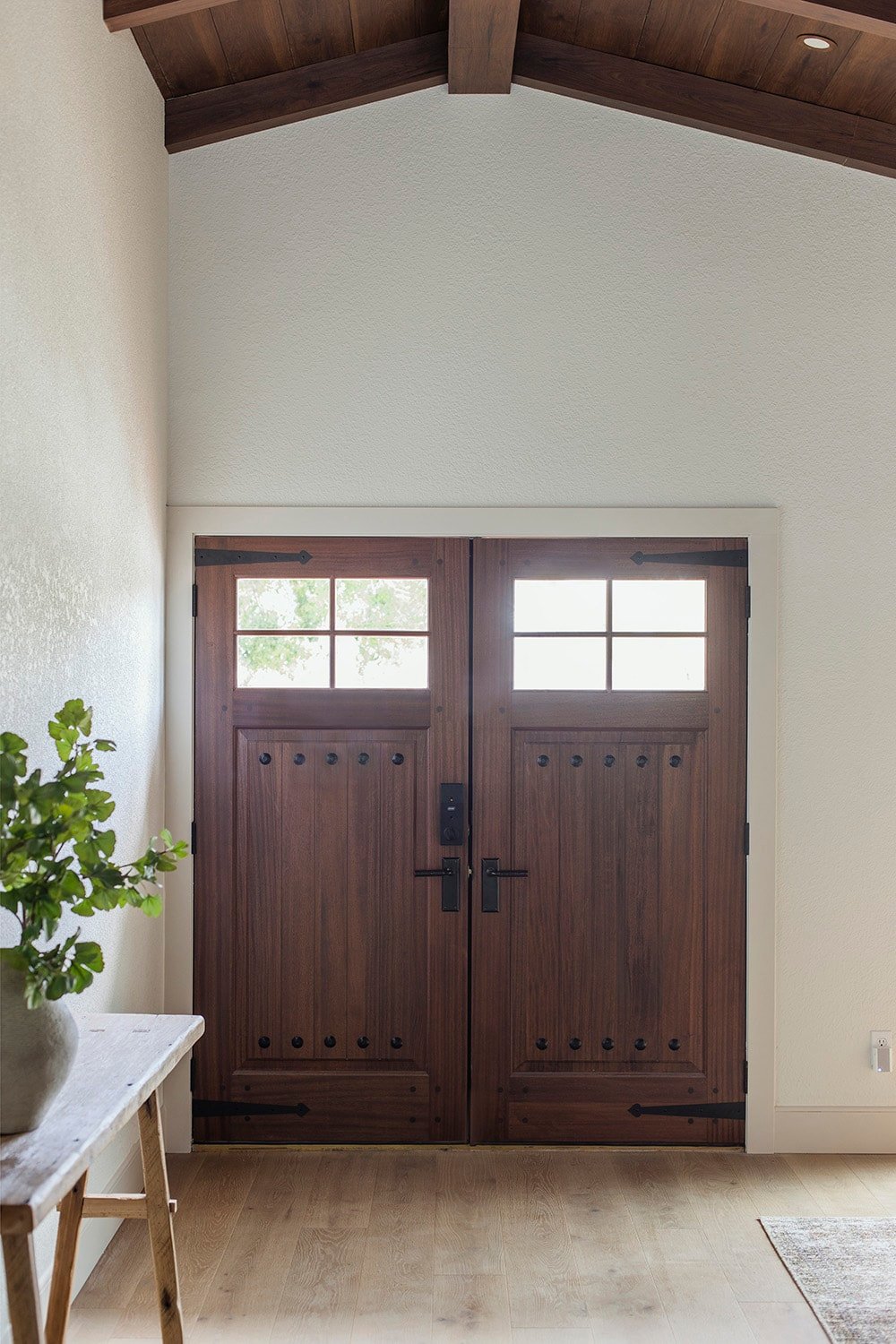 rustic wood front door with metal straps and clavos