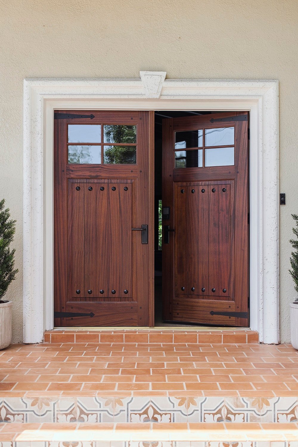 rustic front wood door with decorative black metal hinge straps and clavos