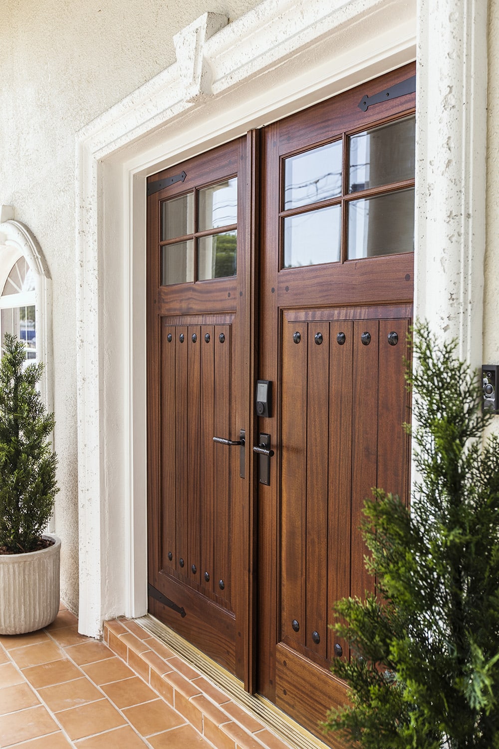 rustic front wood door with decorative black metal hinge straps and clavos