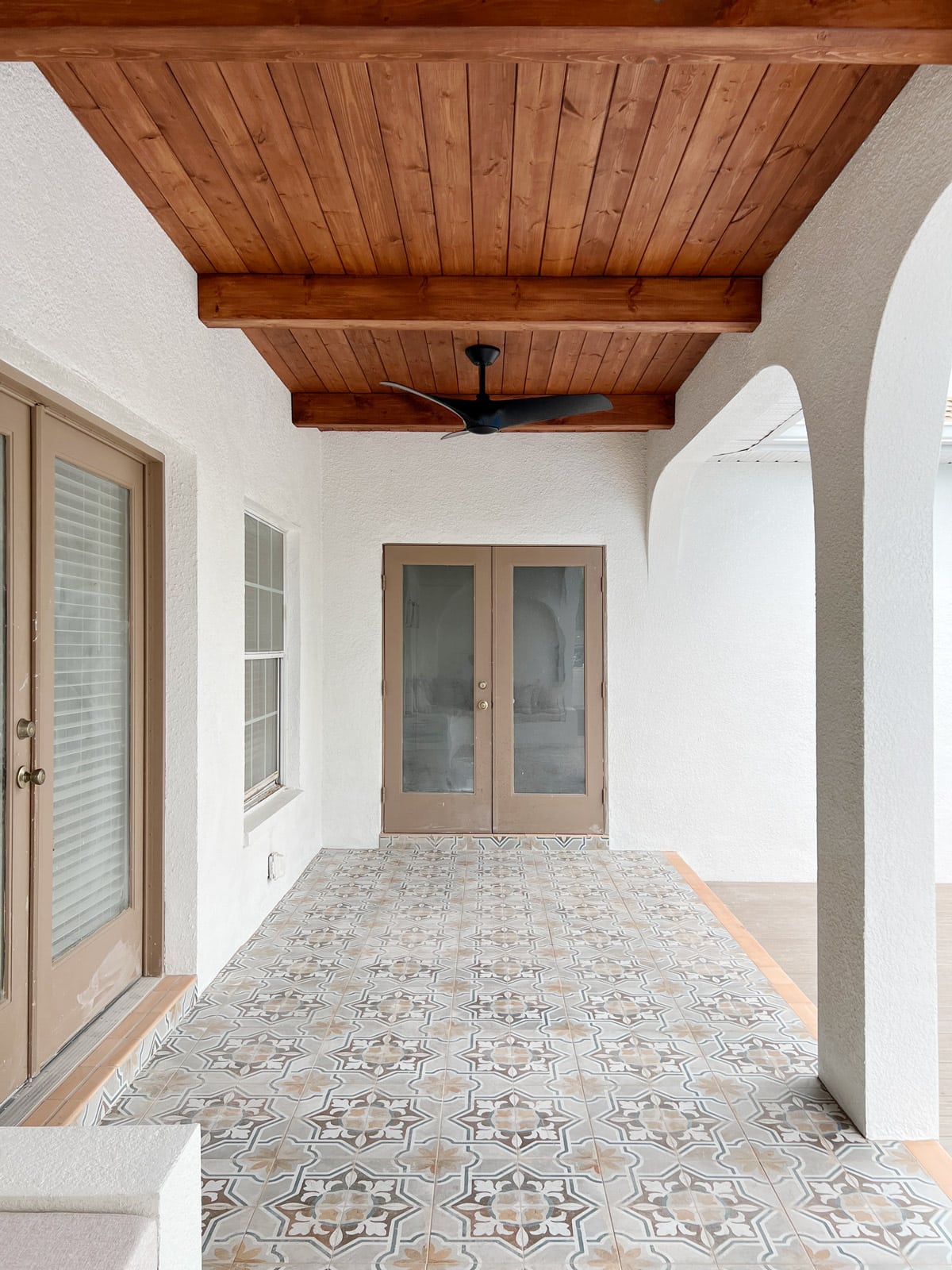 mediterranean porch with wood beam ceiling