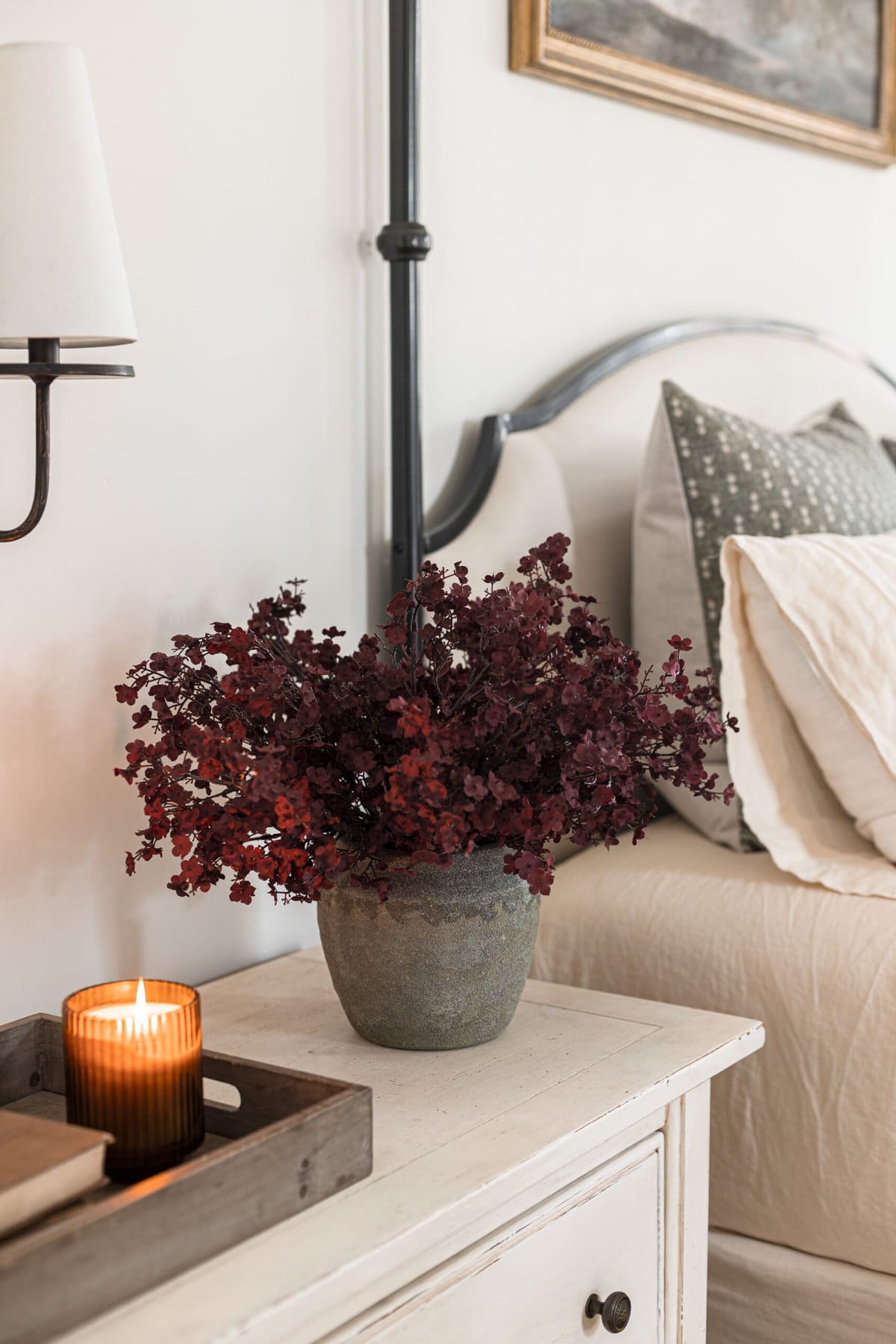 faux burgundy babys breath on night stand