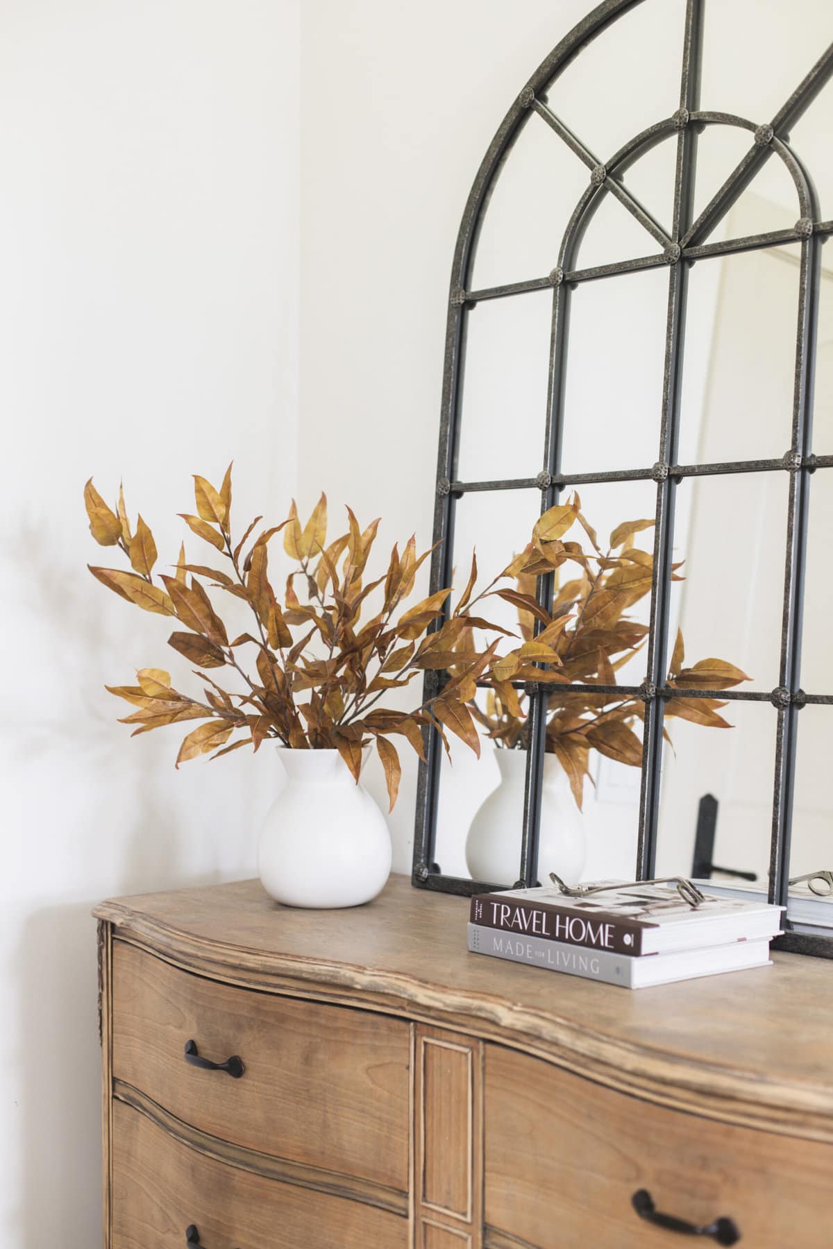 faux fall eucalyptus branches in vase on dresser
