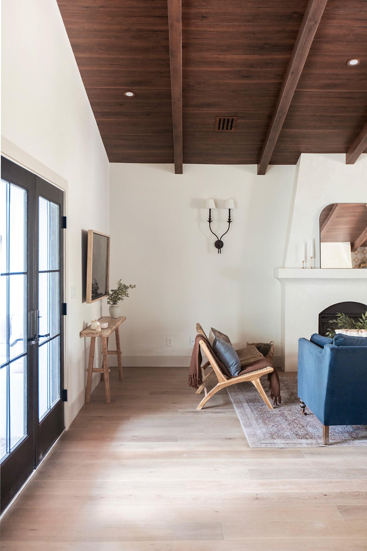 spanish style living room with diy electric fireplace, wood beam ceiling and sw alabaster walls