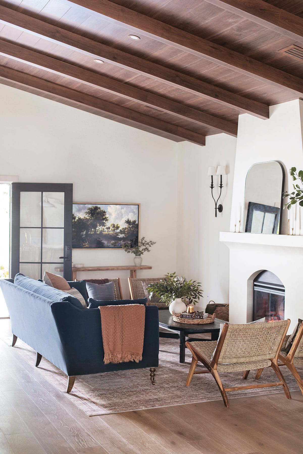 mediterranean style living room with diy electric fireplace, wood beam ceiling and sw alabaster walls