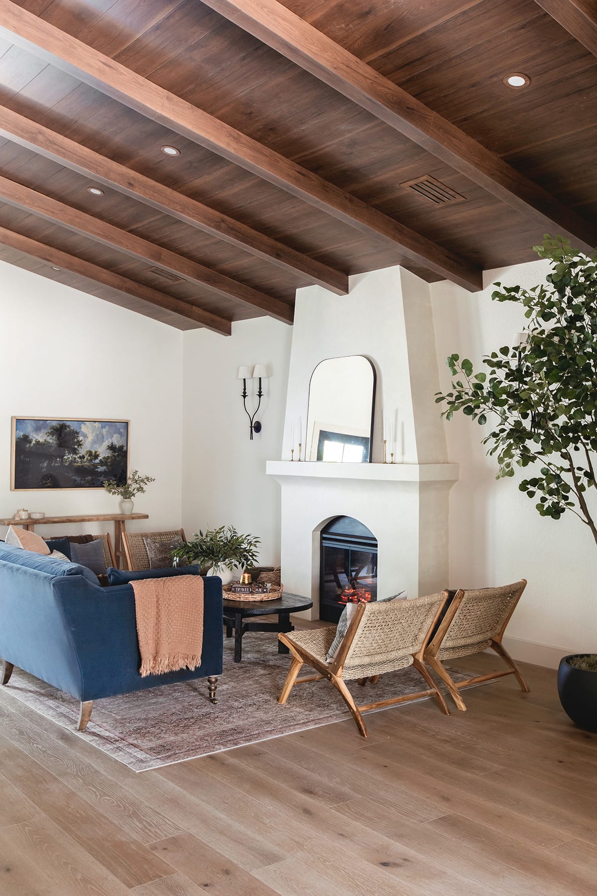 spanish style living room with diy electric fireplace, wood beam ceiling and sw alabaster walls