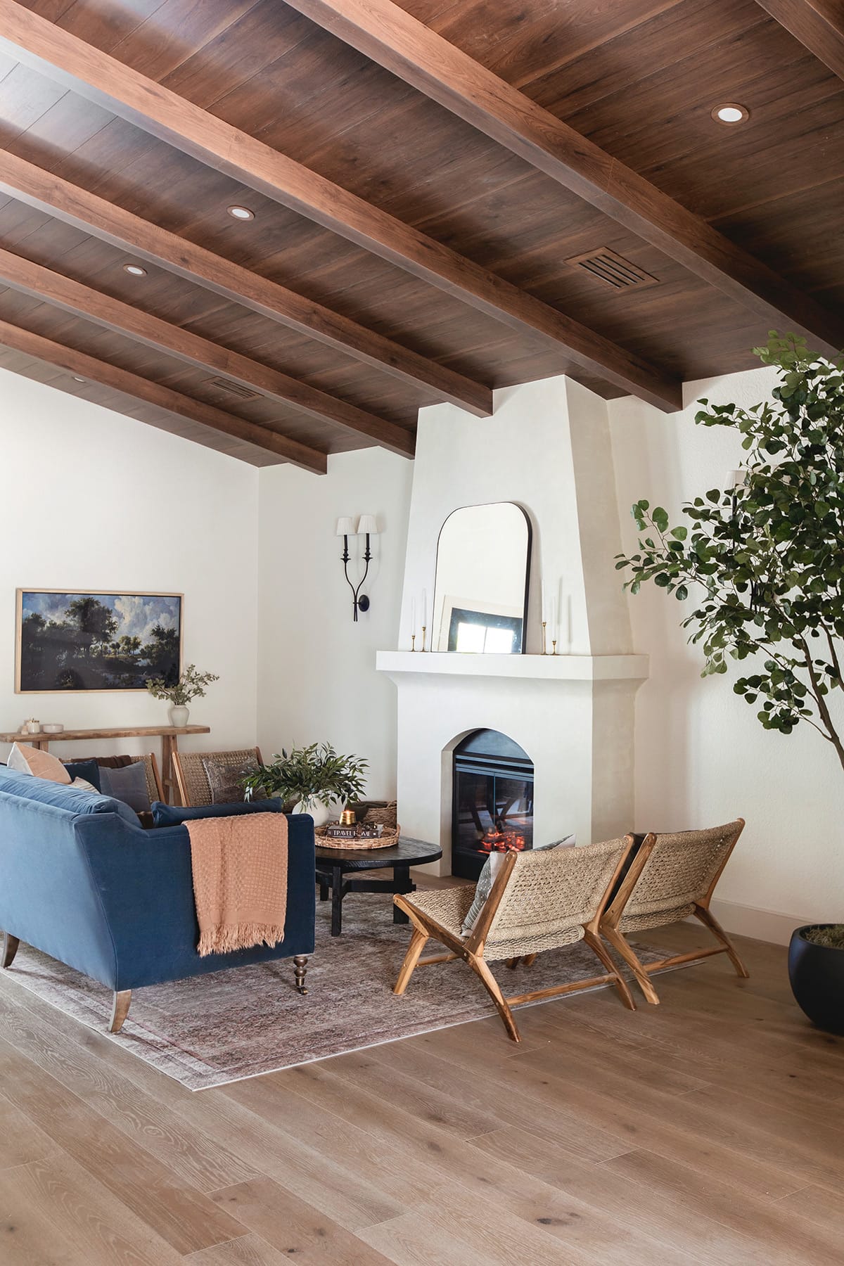 spanish style living room with diy electric fireplace, wood beam ceiling and sw alabaster walls