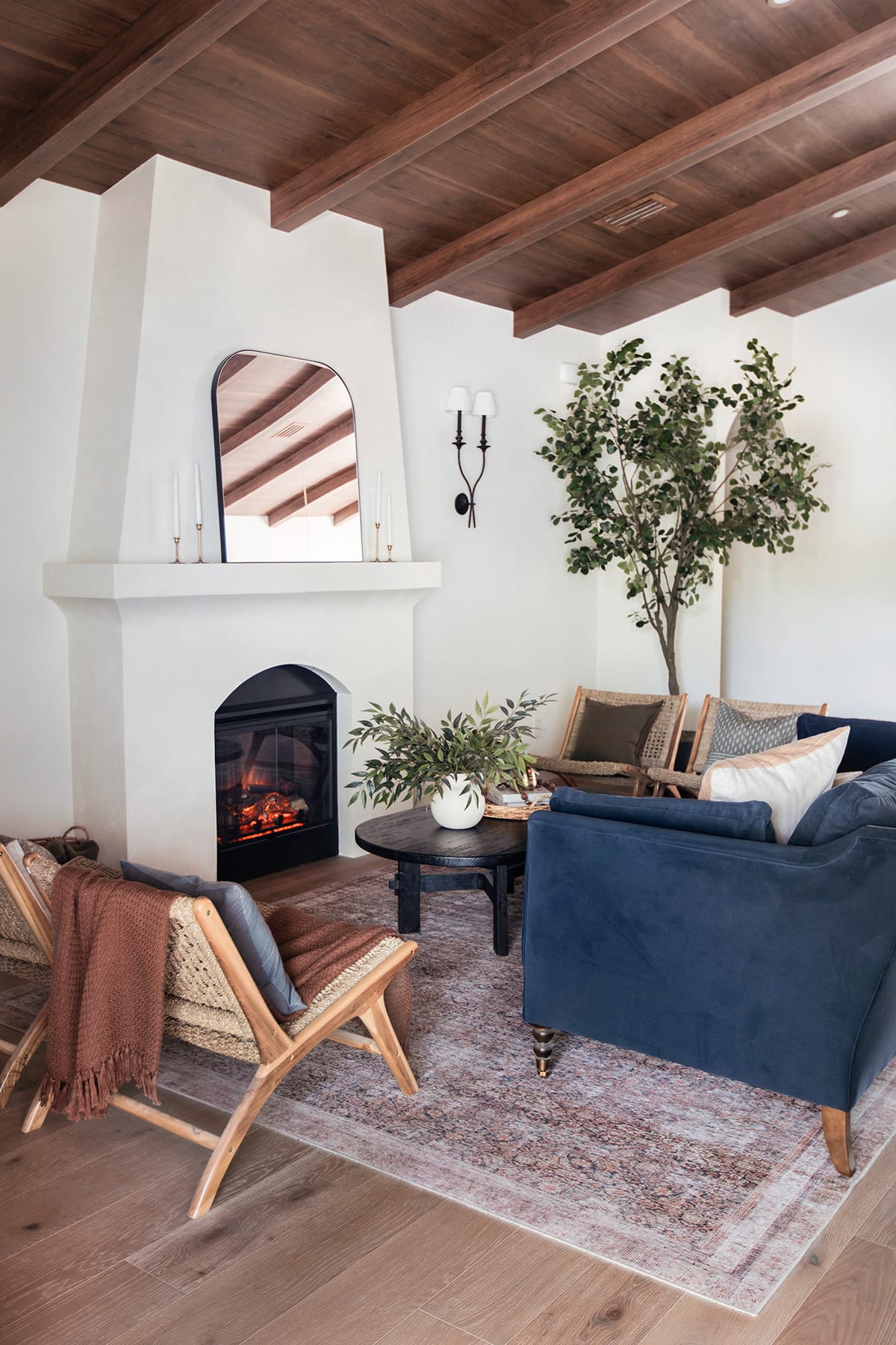 spanish style living room with diy wood beam ceiling and alabaster walls