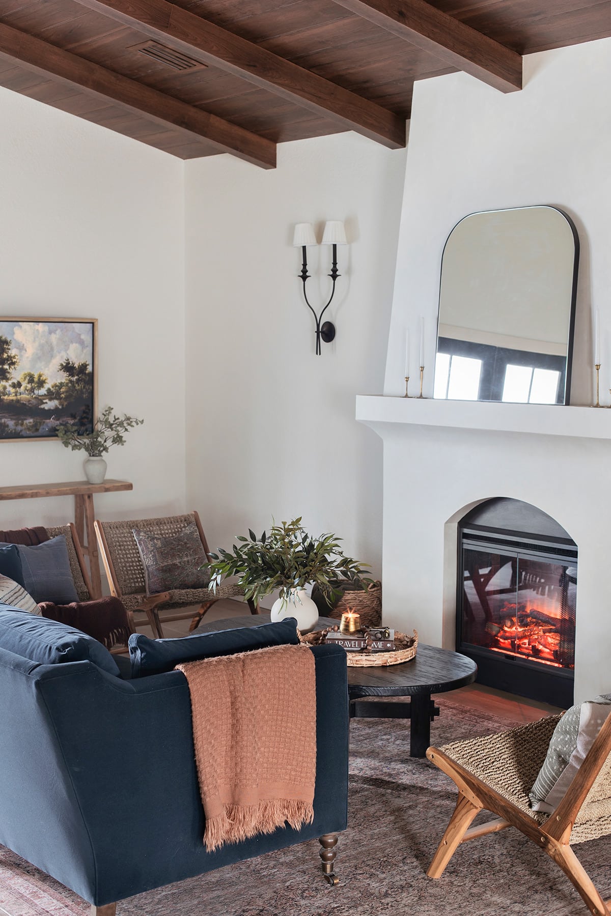 mediterranean style living room with diy electric fireplace, wood beam ceiling and sw alabaster walls